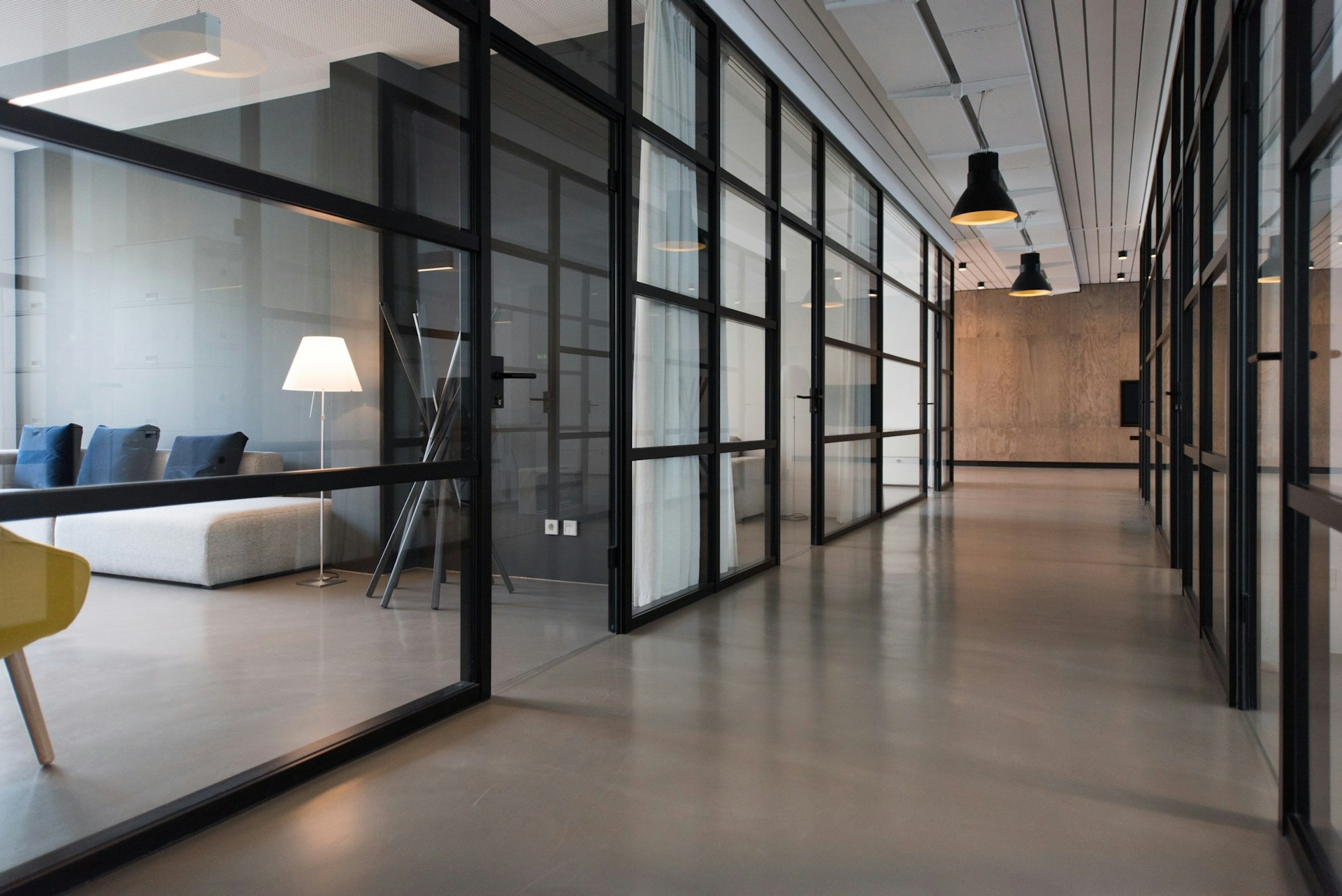 Modern office corridor with glass and warm light